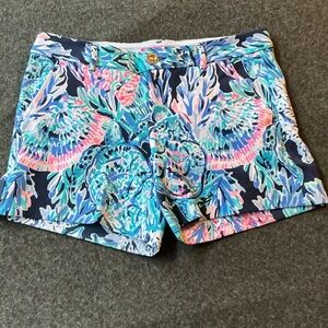 Lilly Pulitzer Callahan shorts in a blue, pink, and teal "Party in Paradise